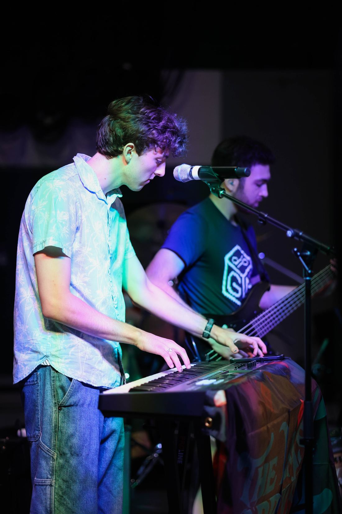 Two members singing at the keyboard