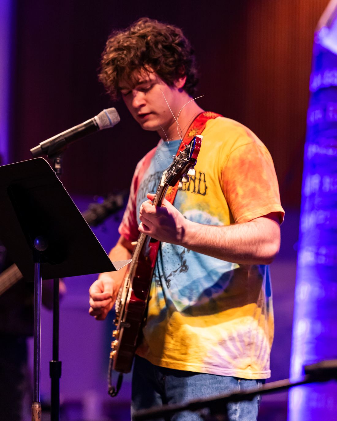 Bass player under purple light